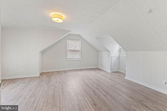 bonus room featuring light hardwood / wood-style flooring and lofted ceiling