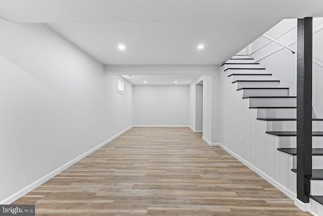 basement with light hardwood / wood-style floors