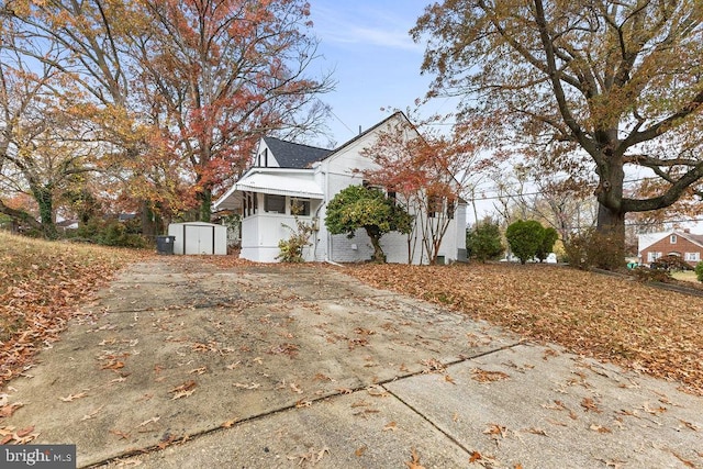 view of home's exterior with a storage unit