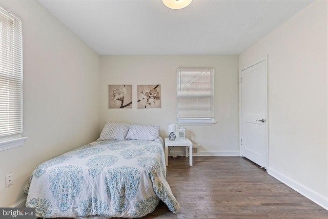 bedroom featuring multiple windows and hardwood / wood-style floors