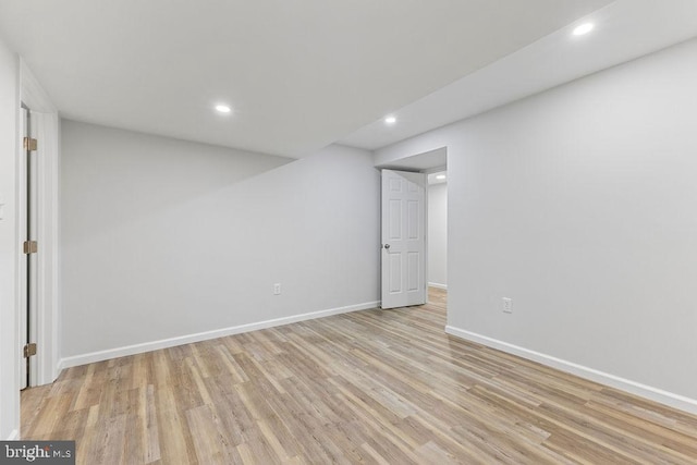 basement with light hardwood / wood-style floors