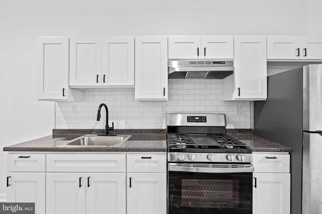 kitchen with white cabinets, decorative backsplash, stainless steel appliances, and sink