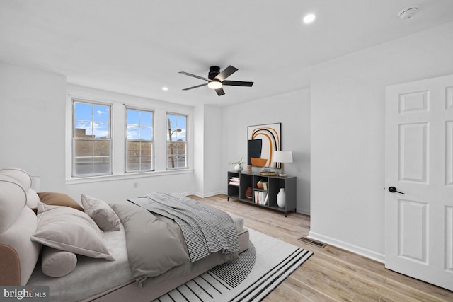 bedroom featuring light hardwood / wood-style floors and ceiling fan