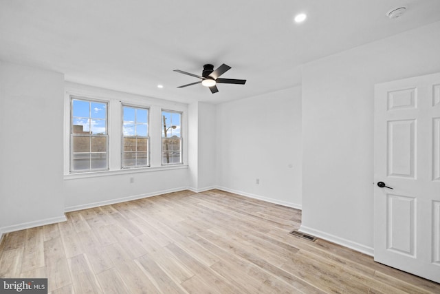 unfurnished room with ceiling fan and light hardwood / wood-style floors