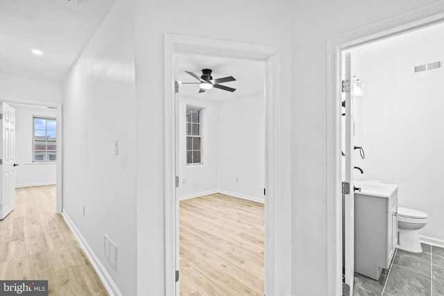 hallway with light hardwood / wood-style flooring