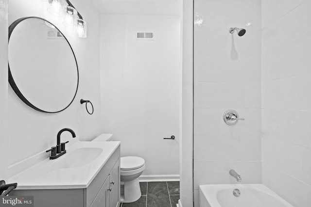 full bathroom with tiled shower / bath, tile patterned flooring, vanity, and toilet