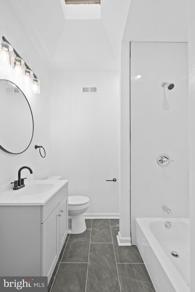 full bathroom featuring tile patterned floors, vanity, toilet, and tiled shower / bath combo