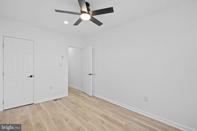 unfurnished bedroom with ceiling fan and light wood-type flooring