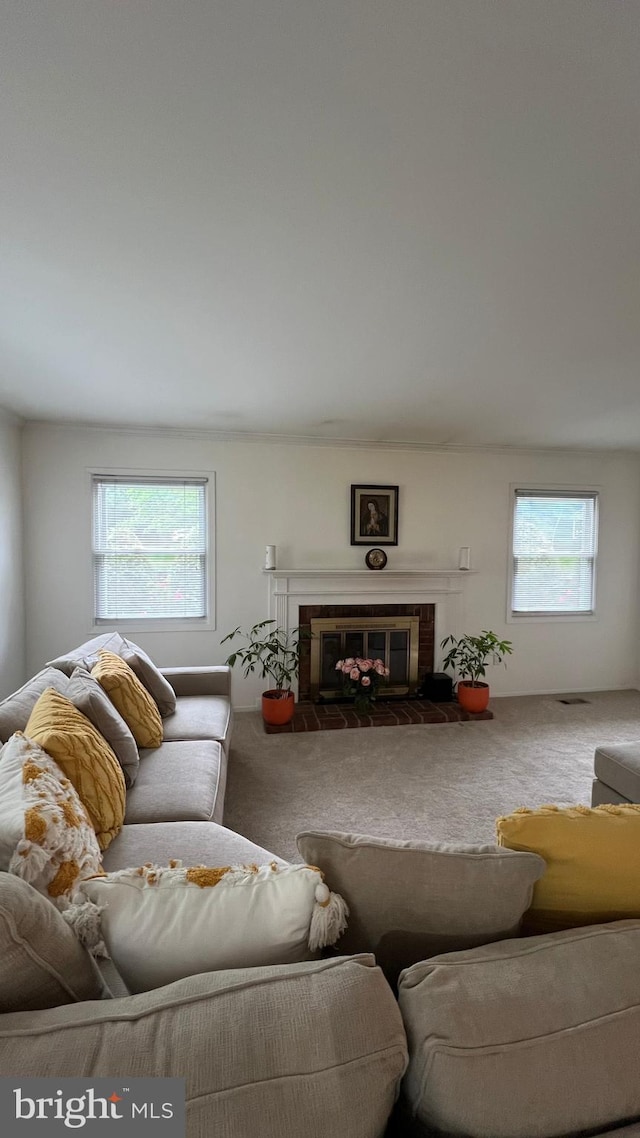 carpeted living room featuring a brick fireplace