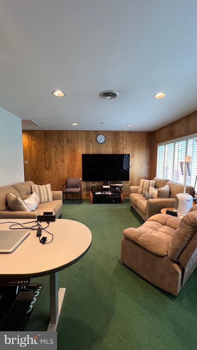 living room with carpet flooring and wood walls