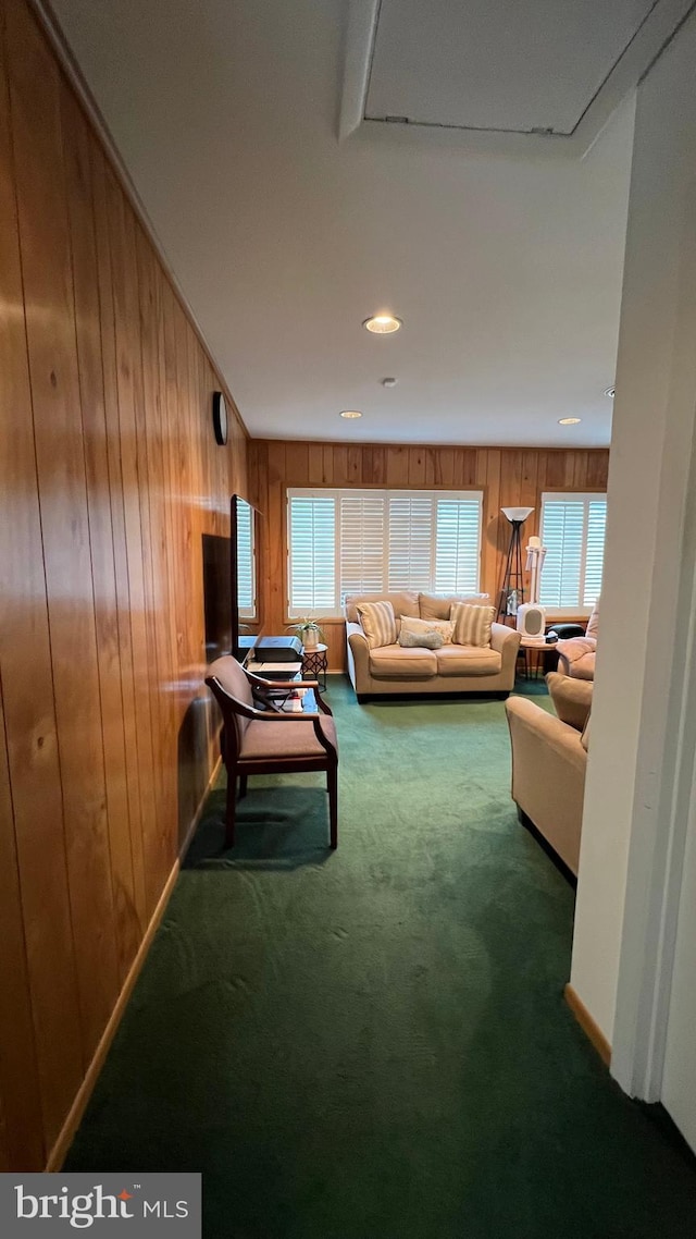 living room with carpet and wooden walls