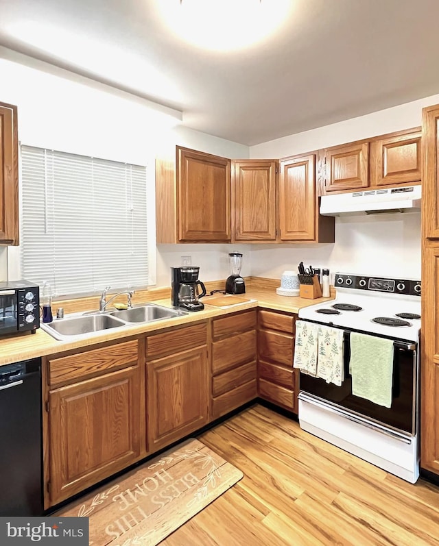 1007 Packton Ln, Bowie, MD 20716 - kitchen featuring black appliances, under cabinet range hood, a sink, light countertops, and light wood-style flooring