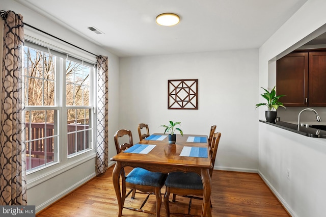 dining area featuring light hardwood / wood-style flooring and sink