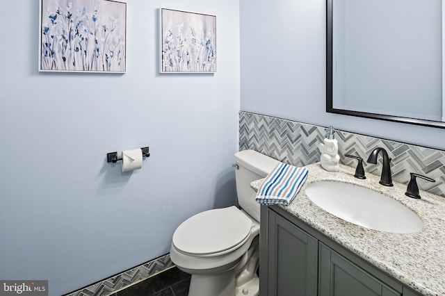 bathroom with tile patterned flooring, vanity, and toilet