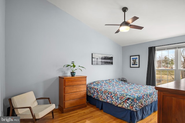 bedroom with ceiling fan, hardwood / wood-style floors, and lofted ceiling