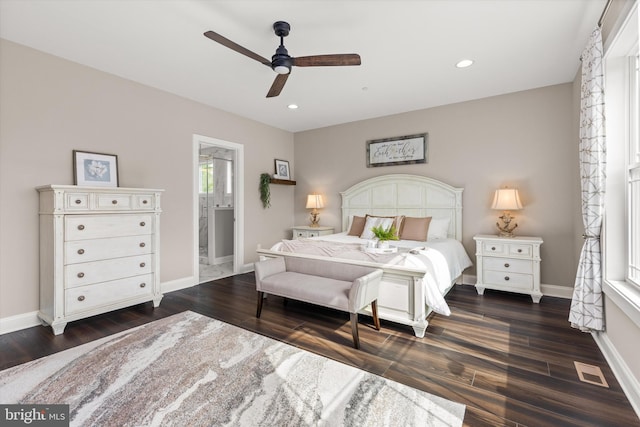 bedroom with ceiling fan, dark hardwood / wood-style flooring, and connected bathroom