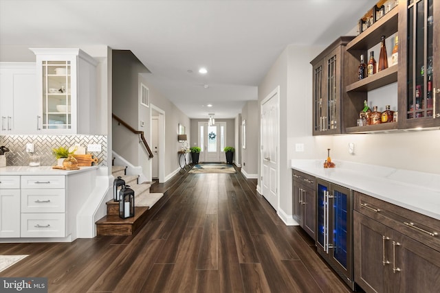 bar with wine cooler, dark brown cabinetry, dark hardwood / wood-style floors, and white cabinetry