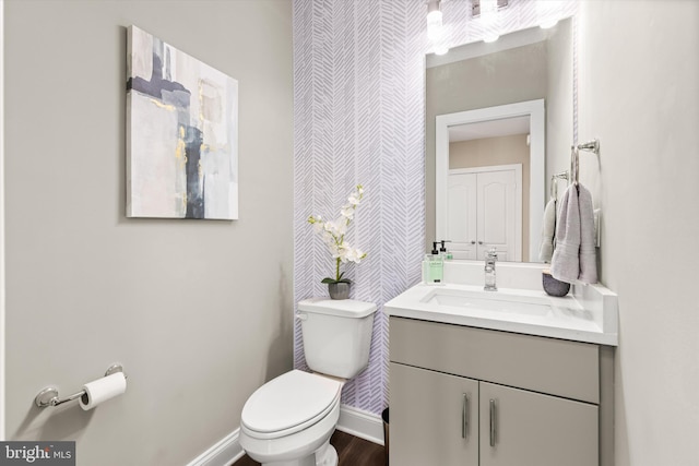 bathroom featuring hardwood / wood-style floors, vanity, and toilet