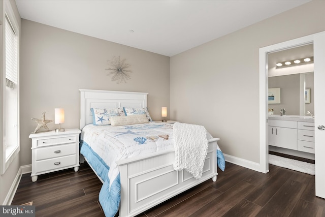 bedroom with ensuite bathroom, dark hardwood / wood-style flooring, and multiple windows