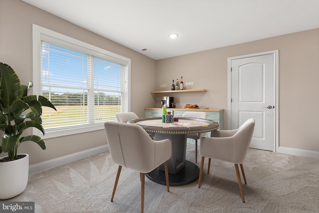 dining room with light carpet