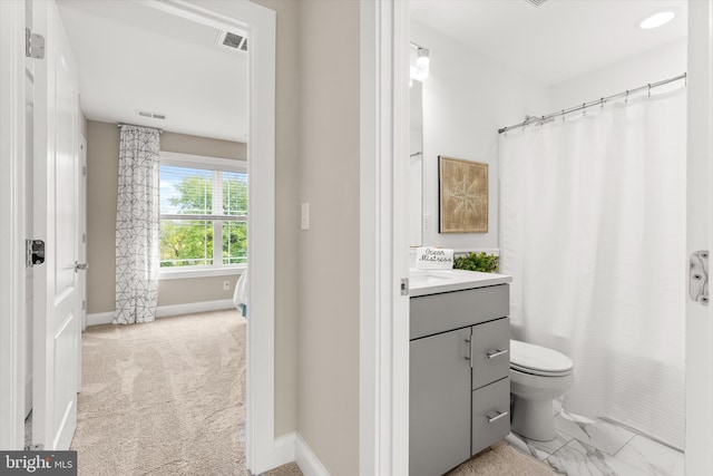 bathroom featuring vanity and toilet