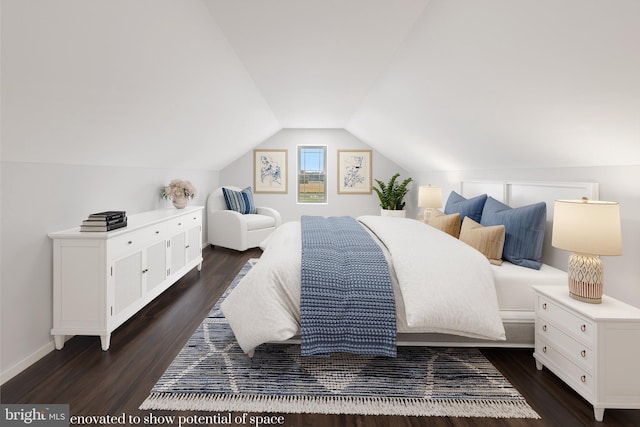 bedroom featuring dark hardwood / wood-style flooring and lofted ceiling