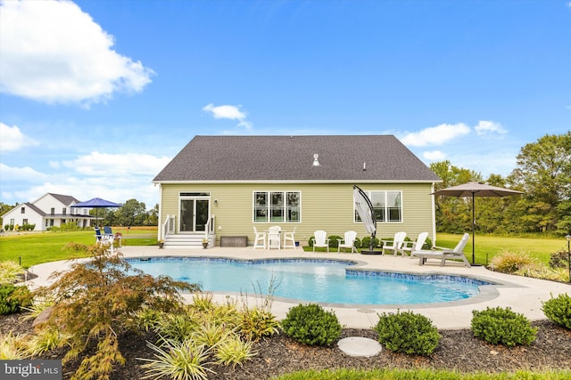 back of house with a lawn and a patio