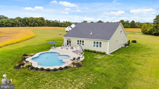 back of property with a lawn, cooling unit, and a patio