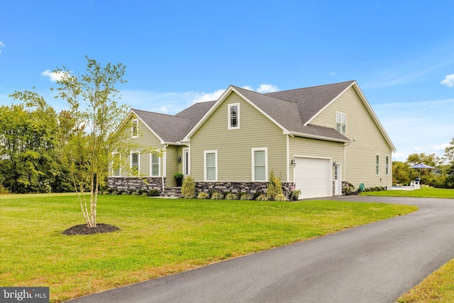 view of front of house with a garage and a front yard