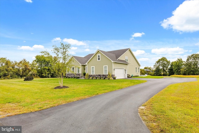 view of front of property featuring a front yard and a garage