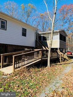 back of house with a wooden deck