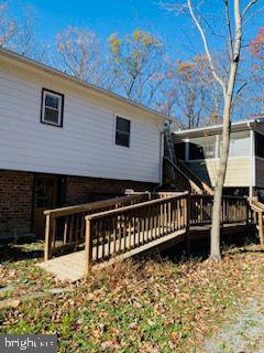 back of house featuring a deck