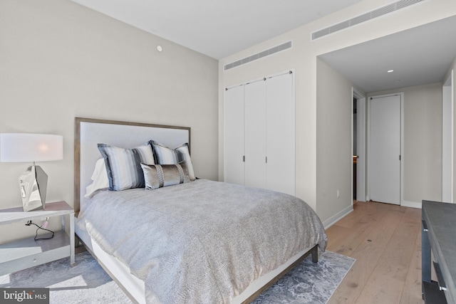 bedroom featuring light hardwood / wood-style floors and a closet