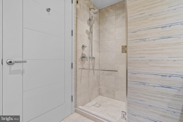 bathroom with a shower with door