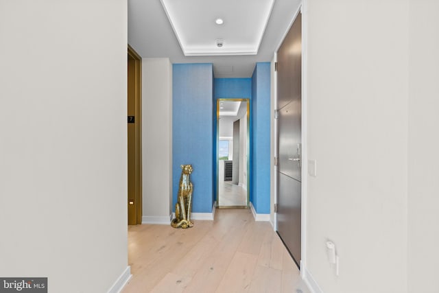 hallway with light hardwood / wood-style floors