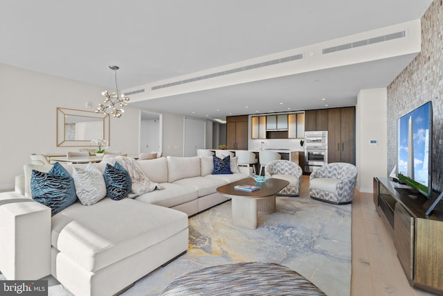 living room featuring a chandelier and light hardwood / wood-style floors