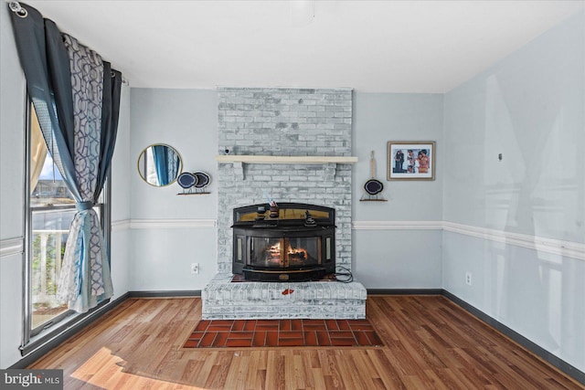 unfurnished living room with a fireplace and dark hardwood / wood-style floors