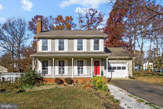 view of property featuring a porch and a garage