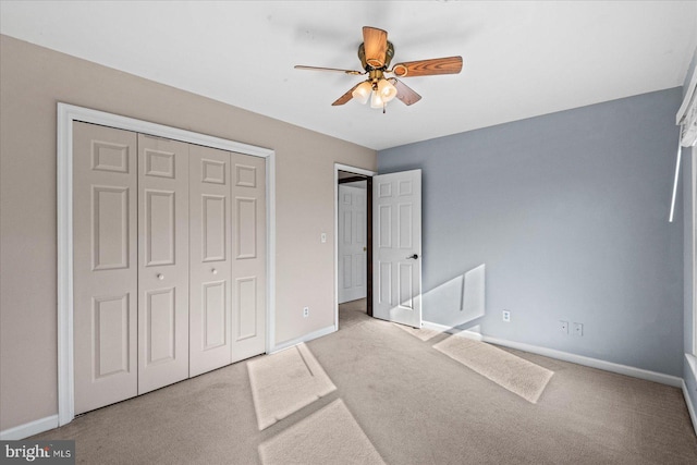 bedroom featuring ceiling fan, light colored carpet, and a closet