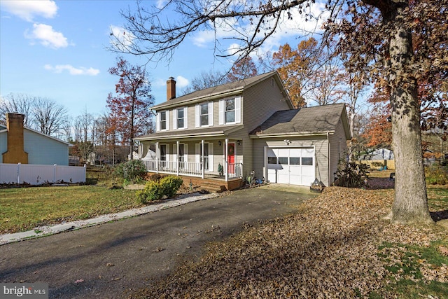 view of front of home with a porch, a garage, and a front lawn