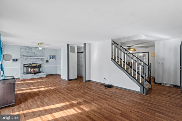 living room featuring a fireplace, ceiling fan, and hardwood / wood-style floors