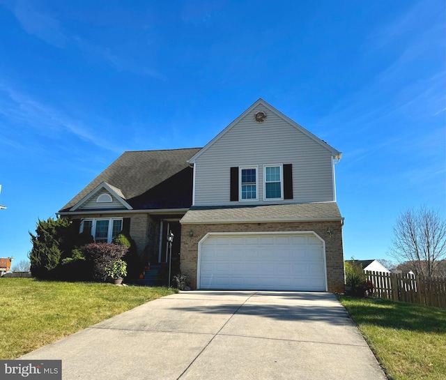 view of front of home featuring a front yard and a garage