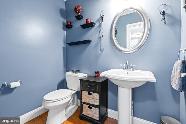 bathroom featuring hardwood / wood-style floors and toilet