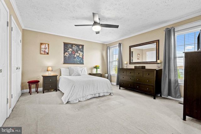 carpeted bedroom with multiple windows, ceiling fan, and a textured ceiling