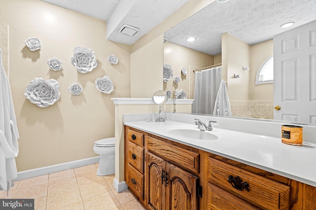 bathroom featuring tile patterned flooring, vanity, a textured ceiling, and toilet