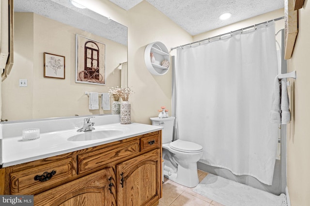 bathroom featuring tile patterned floors, vanity, toilet, and a textured ceiling