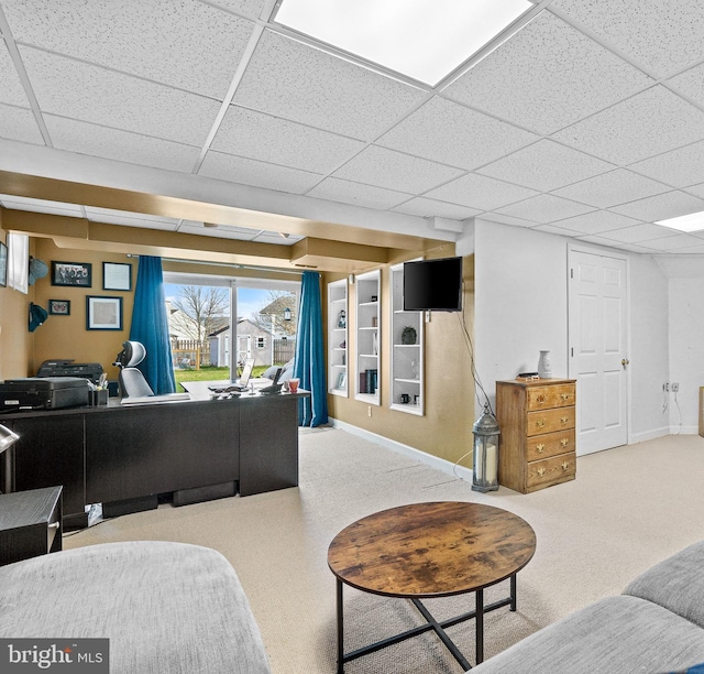 living room with carpet flooring and a drop ceiling