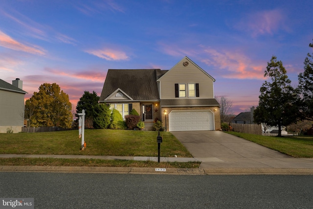 view of front of property featuring a garage and a lawn