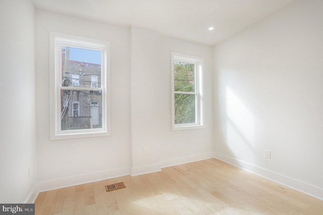 unfurnished room with light wood-type flooring