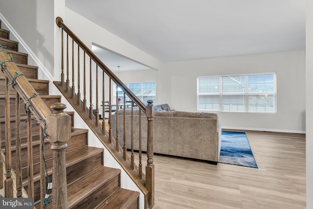 living room with a notable chandelier and light hardwood / wood-style flooring